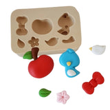 Molde de silicona con apliques de cuento infantil para porcelana fría, incluye manzana, lazo, pajarito y flores decorativas de Simone Moldes.